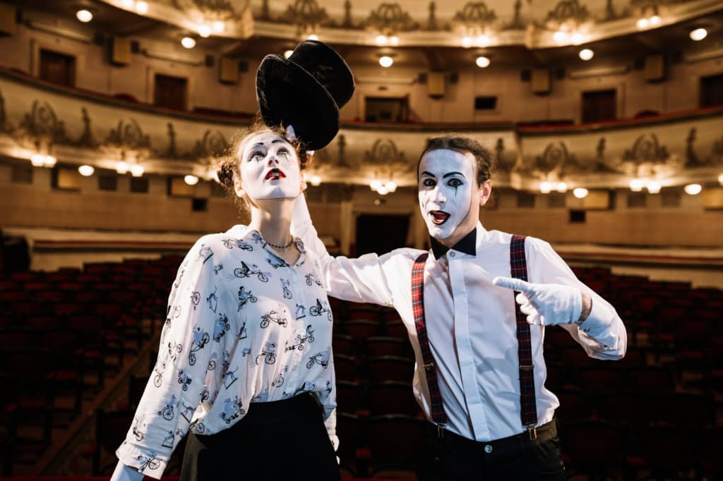 Female and male mime artist performing on stage